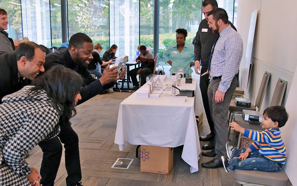 Krishna Udayakumar, left, watches his son have his passport taken at last year's Duke Passport Drive. Photo courtesy of the Duke Office for Global Affairs.