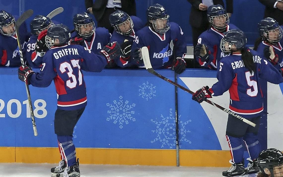 Randi Griffin, left, celebrates her goal against Japan in the Winter Olympics with teammates on the Korean women's ice hockey team. Photo courtesy of the Korean Ice Hockey Association.