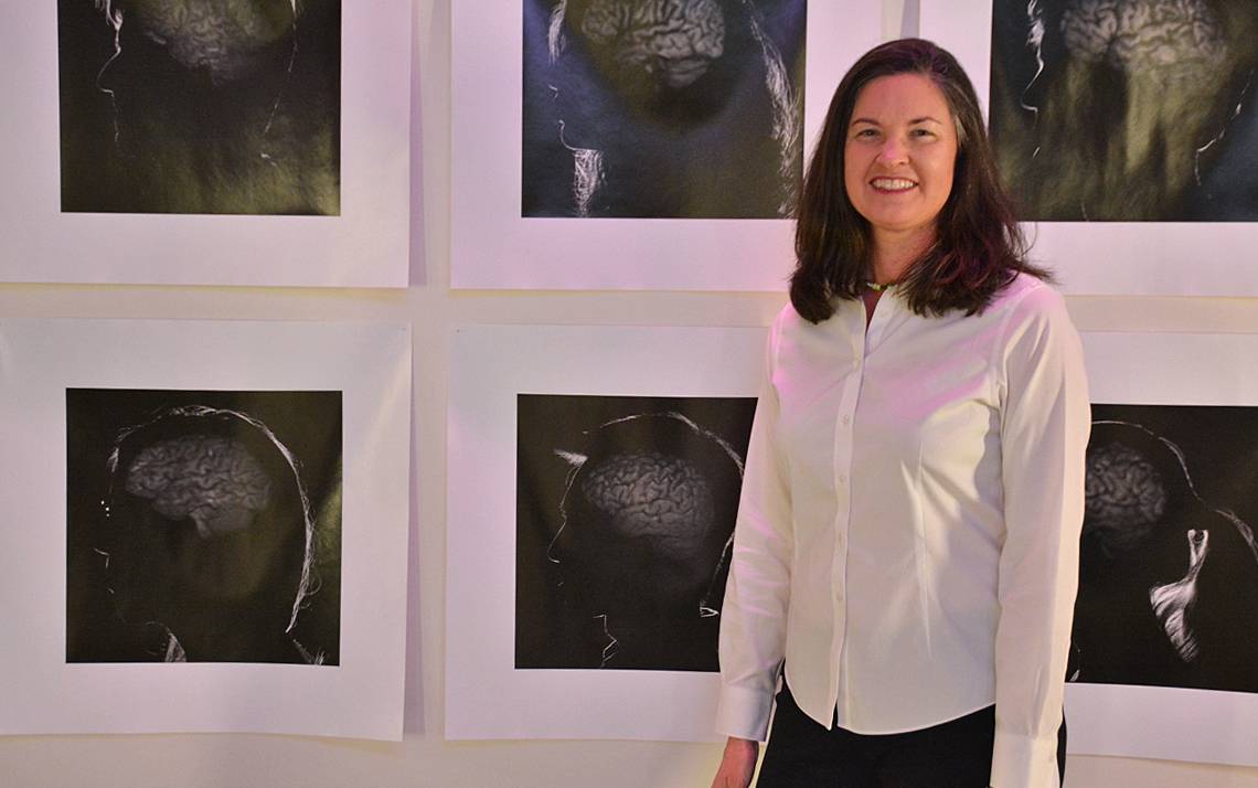 Nicole Schramm-Sapyta stands in front of a mural of brains in the Duke Institute for Brain Sciences office. Photos by Jonathan Black.