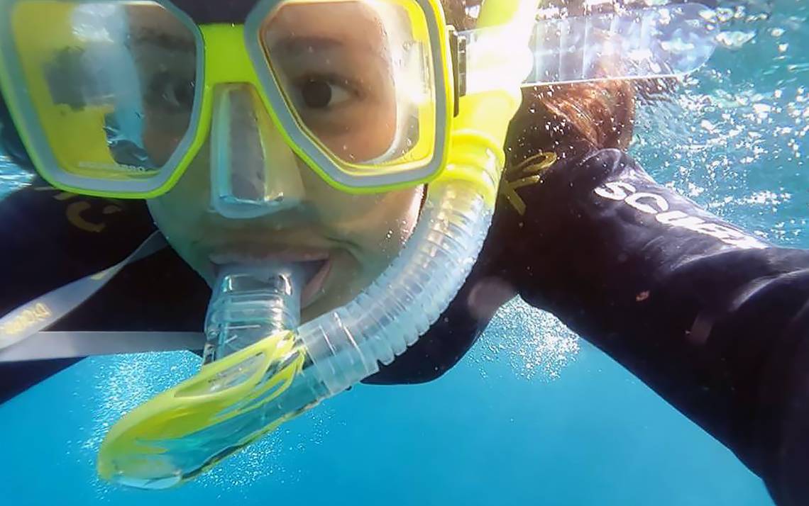 Simone Pitre of Duke's Innovations in Healthcare snorkels during #DukeTimeOff in Australia.