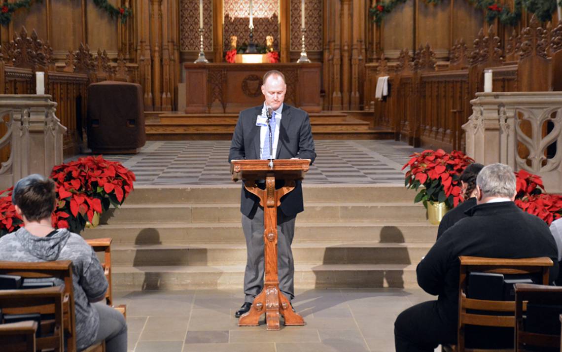 Artie Hendricks, clinical chaplain of palliative care and bereavement services, reads the names of employees who have passed away during the 2019