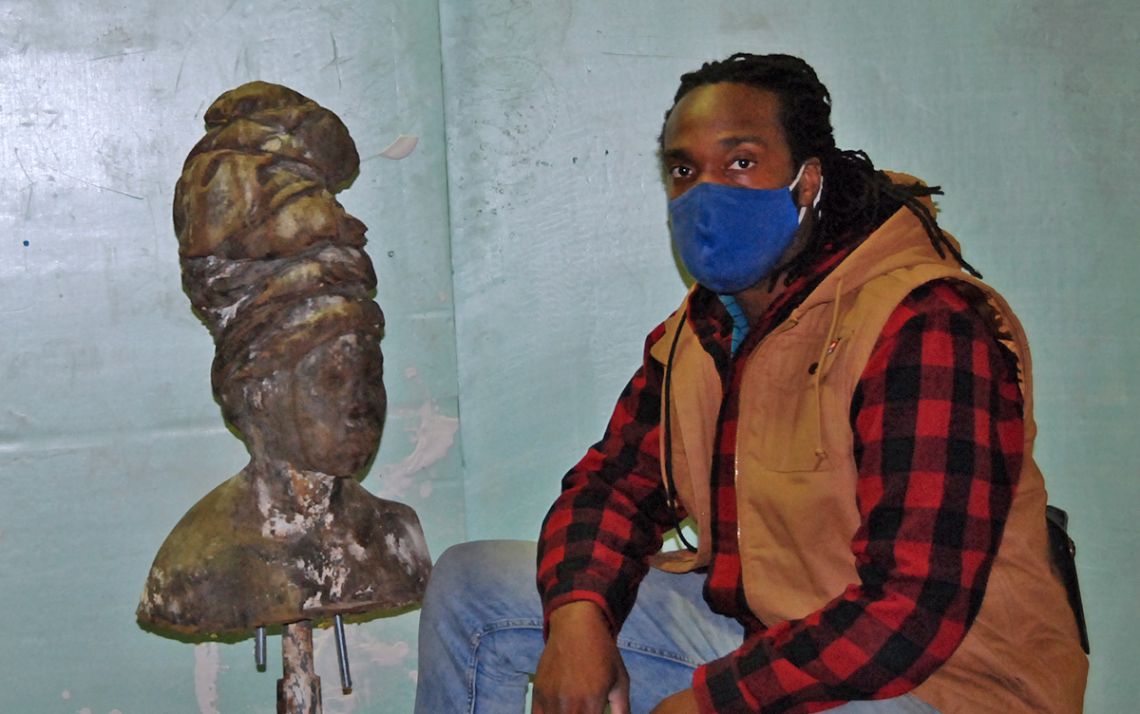 Stephen Hayes, pictured here next to a sculpture project, creates art that speaks to the Black experience. Photo by Jack Frederick.