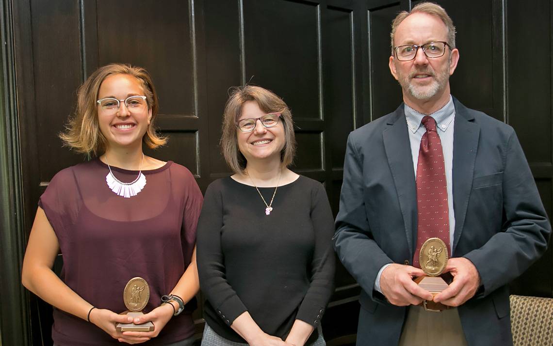 Sullivan Award winners Lauren Harper, left, and Rick Hoyle, right, received their awards from Provost Sally Kornbluth, center, on Friday.