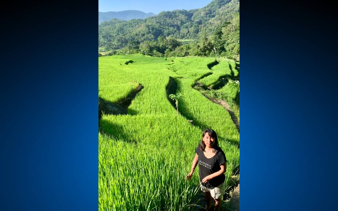 Trinidad Abe poses for a photo in front of rice paddies in Ifugao, a landlocked province in the northern neck of the Philippines. Photo courtesy of Trinidad Abe.