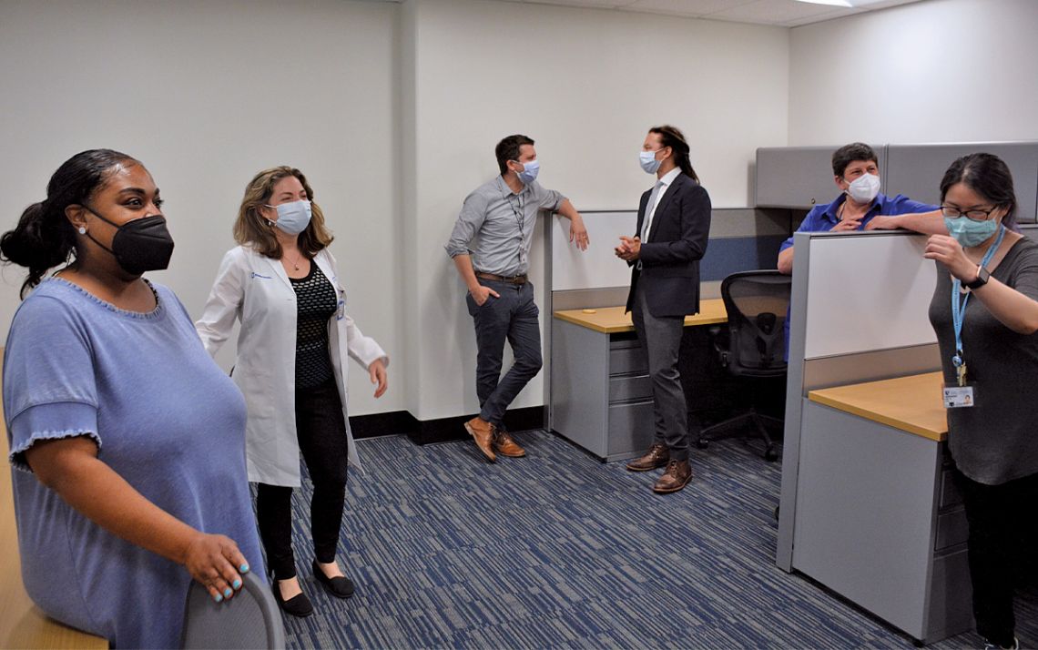 Duke Aging Center Director Dr. Heather Whitson, second from left, shows off the center's new shared workspace. Photo by Stephen Schramm.