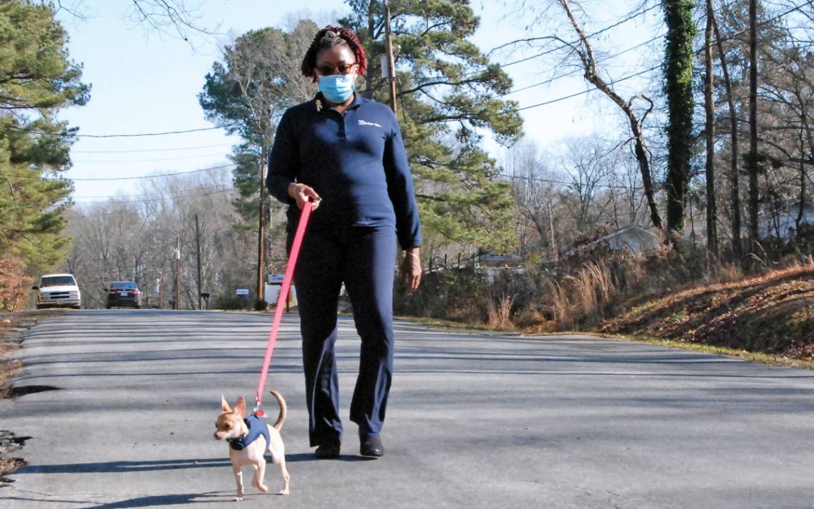 Wanda Amons and her dog, Cola, take a walk near Amons' Durham home. Photo by Stephen Schramm.