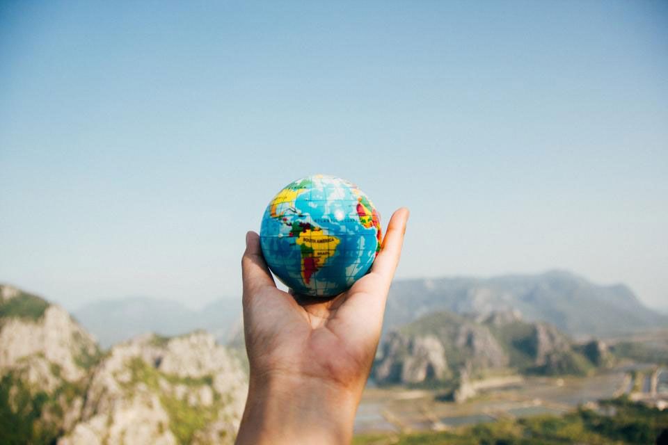 small globe held in a hand