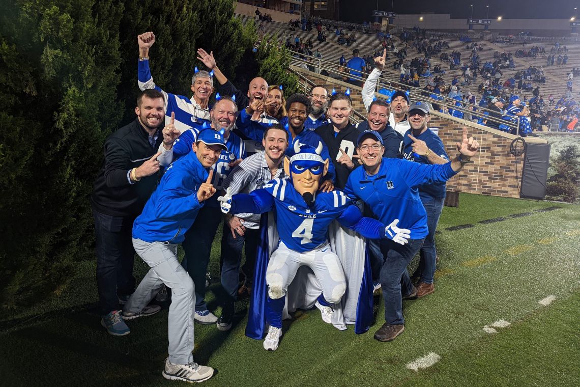 Blue Devil mascots at the reunion join the current mascot on the Wallace Wade Stadium field