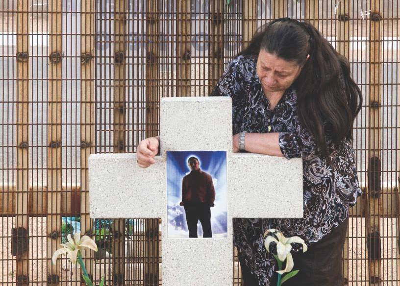 A woman mourns her grandson marking the spot where he was killed by a border agent in 2011.