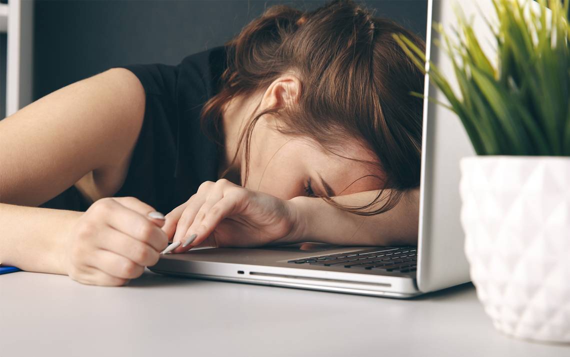 A woman asleep at her desk.