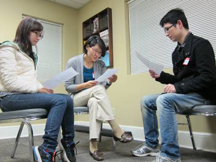 SangHee Jeong, program coordinator with the International House, center, practices her Chinese at a recent Chinese Conversation Club. It's one of sevearl weekly language and cultural learning groups offered through Duke's International House. Photo by Br