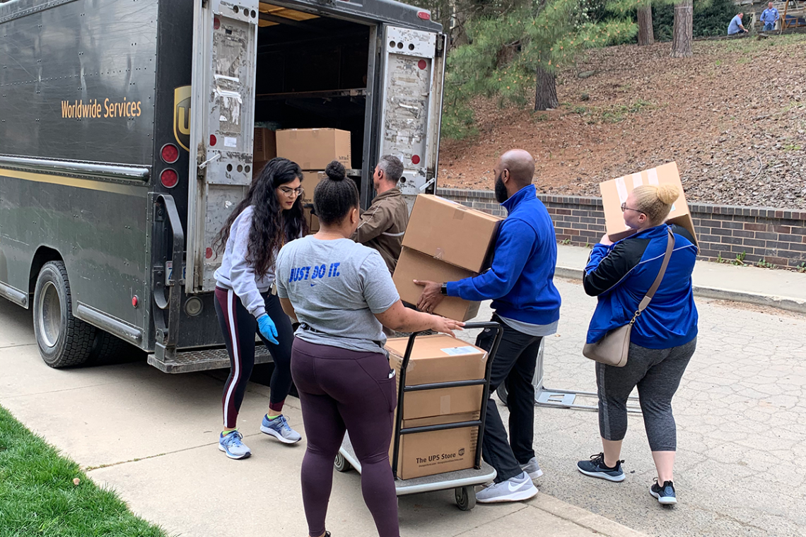 duke staff move packages to be shipped to students during Spring Break week.