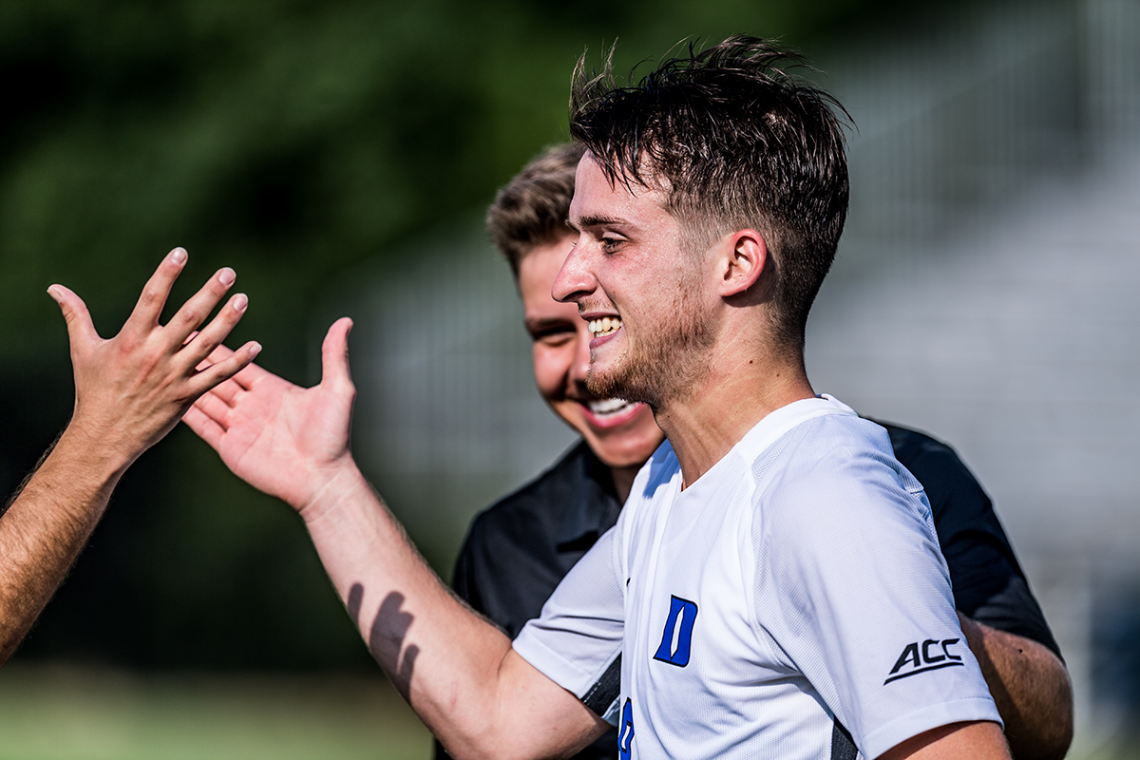 Daniele Proch with teammates on the soccer field