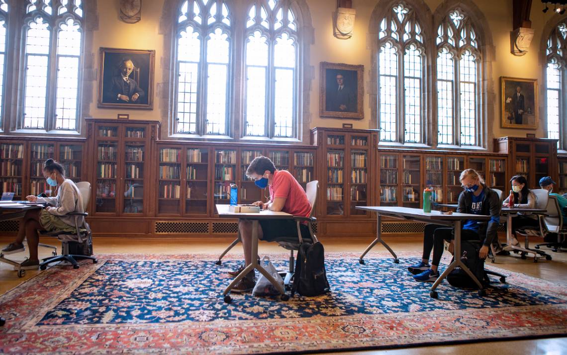 Wearing masks and physically distanced, students study in the Gothic Reading Room of Perkins Library. Photo by Jared Lazarus, Duke University Communications.