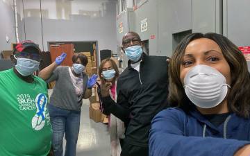 Monique Turrentine, far right, takes a selfie with volunteers who packed up boxes of non-perishable food to donate. Photo courtesy of Monique Turrentine.