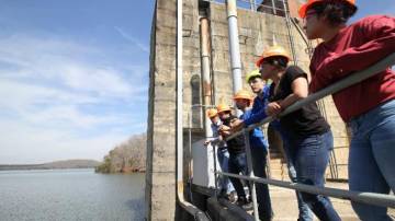 Faculty member Neal Simmons (far left) leads students on a tour of Cube Hydro's Badin Lake facility. Students, left to right: Uriel Salazar, Laura Perez, Sahil Mehta, Hunter McNamara, and Laura Perez. Perez will intern at Cube Hydro this summer.