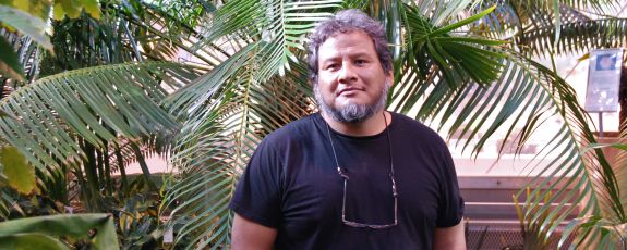 Jorge Fidhel Gonzalez stands in the Duke Biology Greenhouses.
