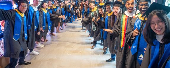 New DKU graduates excitedly prepare for the procession into the Karsh Center ceremony. Photo by Bill Snead