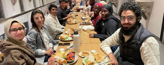 Rashad Rahman, third from left, and other Muslim students eating on campus during Ramadan in an iftar organized by the Center for Muslim Life.