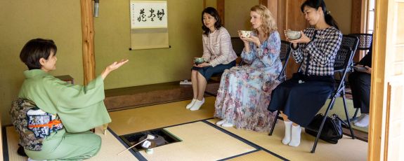 Chizuko Sueyoshi, leader of the Japanese Tea Practitioners of Durham, hosts a traditional Japanese tea gathering for Yuko Kishida, spouse of the prime minister of Japan; Kristin Cooper, first lady of North Carolina; and Mio (Yamamoto) Maeda, spouse of consul general of Japan in Atlanta, in the Durham-Toyama Sister Cities Tea Pavilion in the Ruth Mary Meyer Japanese Garden, which is part of the Culberson Asiatic Arboretum in the Sarah P. Duke Gardens.  