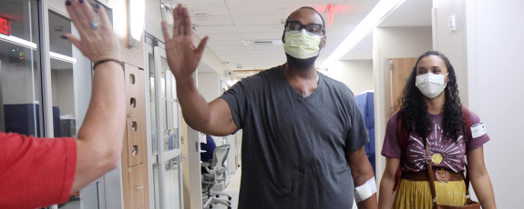 Heart patient Donavan Harbison walks with his wife Lindsey Harbison following the operation.