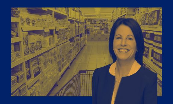 Alison Taylor super imposed on a supermarket aisle using Duke Climate Commitment stylized branding