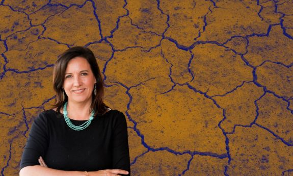 Ashley Ward against a background of bare ground, cracked by heat