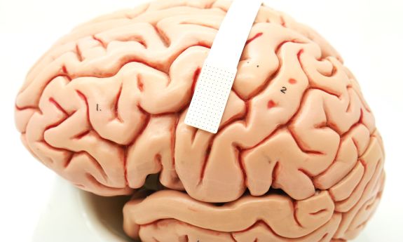 A device no bigger than a postage stamp packs 128 microscopic sensors that can translate brain cell activity into what someone intends to say (photograph by Dan Vahaba/Duke University).