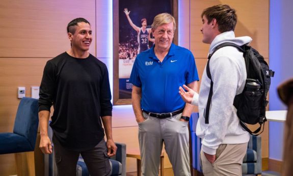 Lacrosse legend Lyle Thompson, left, and Duke lacrosse coach John Danowski talk with students following Thompson’s presentation at the Champions Club.