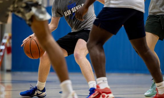 Basketball players play a game at Duke