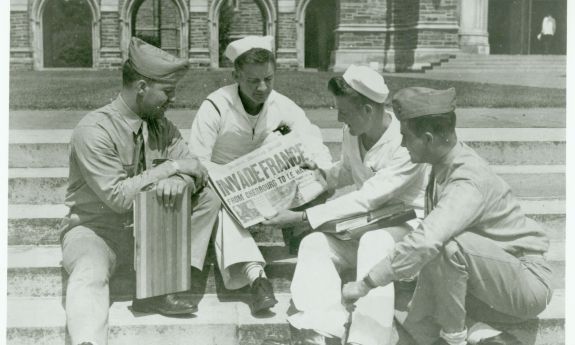 This photo was taken on D-Day—June 6, 1944—on the Duke Chapel steps as members of Duke’s Navy College Training Program read a headline about the Invasion of Normandy from the Durham Morning Herald newspaper. Courtesy Duke University Archives