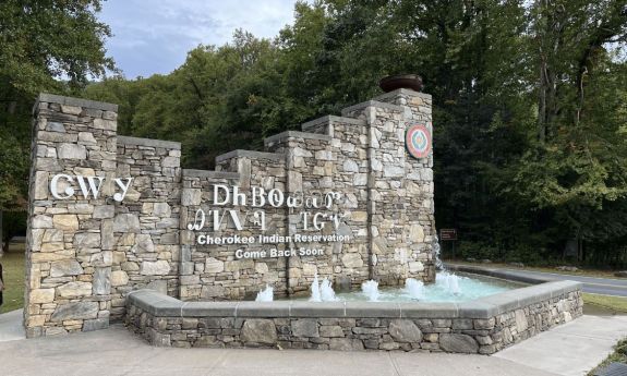 Sign made of stone with Cherokee language on it.