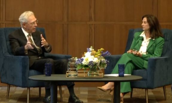 Pearson and Biddle sitting in chairs talking