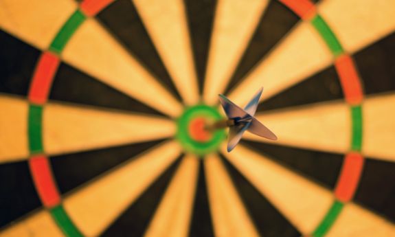 A dart hitting a bullseye