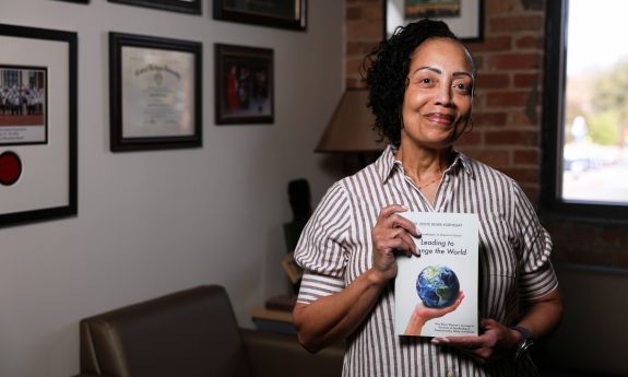 Leslye Kornegay holds her book, "Leading to Change the World"