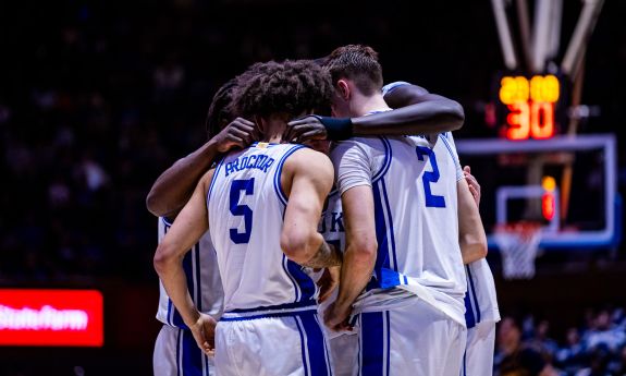 Duke men's basketball players gather in a team huddle