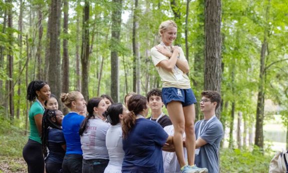 Student falling into a group of students