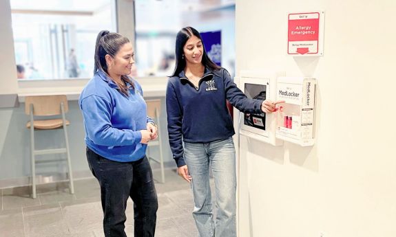 Two people by an allergy station