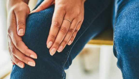 stock image of man with painful knee