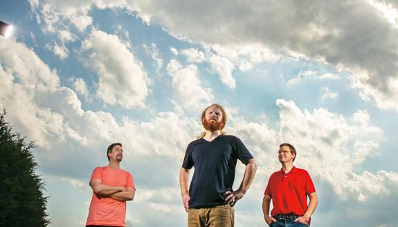 Under telling skies, scientists Andy Bragg, Jason Scot Simon and Nate Chaney gathered at Chaney's farm in Rougemont. Photo by Chris Hildreth