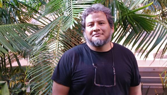 Jorge Fidhel Gonzalez stands in the Duke Biology Greenhouses. 