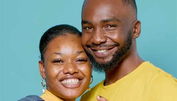 Two people smiling and embracing