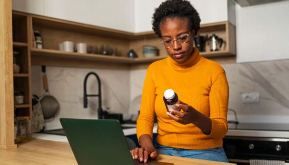 stock image of woman looking at pill container