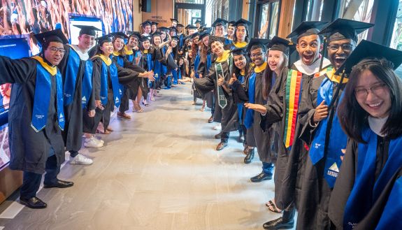 New DKU graduates excitedly prepare for the procession into the Karsh Center ceremony. Photo by Bill Snead