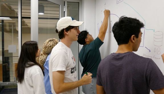 Code+ students work on a coding project. 