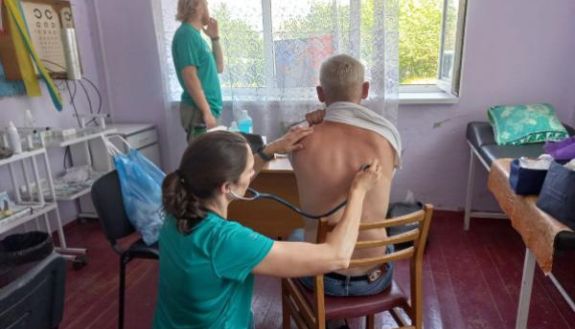 Health care worker examining patient