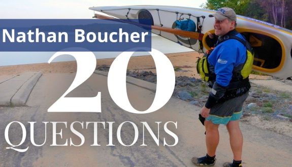 Nathan Boucher holding a kayak on 20 Questions video thumbnail