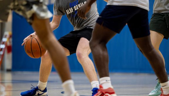 Basketball players play a game at Duke