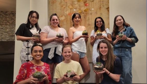 Women in Economics group make terrariums as one of their activities. Back from left to right: Wanrong Deng, Catherine Gonzalez, Bomi Kang, Hema Shah, Shipeng Fu. Front from left to right: Neha Gupta, Julie Bennett and Tirza Angerhofer.