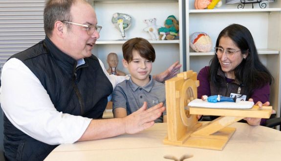 From left: Cancer survivor Seth Cuni, and his son Roman, attend sessions with DCI Child Life Specialist Micah Sedillos, and Cuni's daughter Audrey.